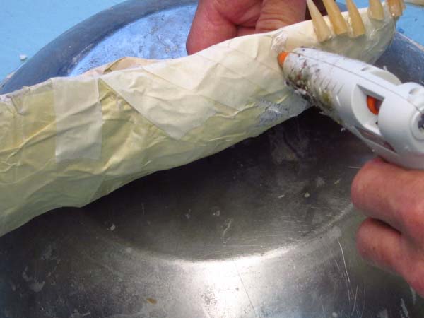 Paper Mache Dragon Build-adding teeth with hot glue